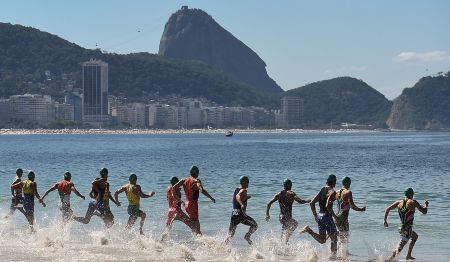 Swimmers enter the water on Copacabana Beach