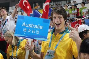 Max Hughes holding the sign for the Australian Youth Olympic Team