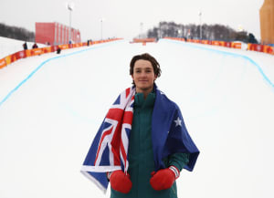 Scotty James with his Aussie flag after winning bronze in the snowboard halfpipe