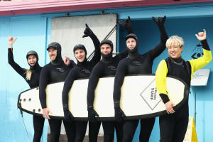 Danielle Scott, Scott Kneller, James Matheson, Harry Laidlaw and Rohan Chapman-Davies of Australia with Changwoo Woo participate in the Aussie Athletes Go Surfing in the cold waters of Yeongjin-gil Beach